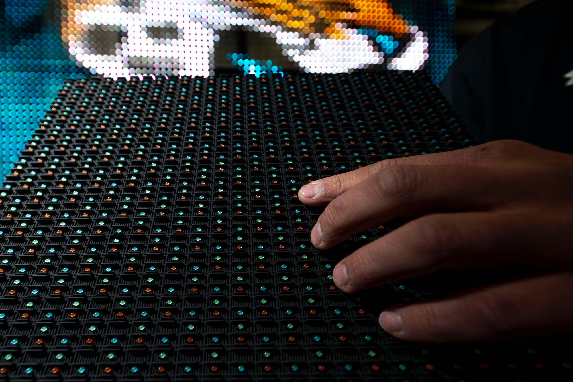 LED Board with Hand Aaron C. Packard Photography Industry